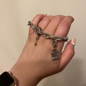 Judith Ripka silver chain bracelet with key charm and lock charm.